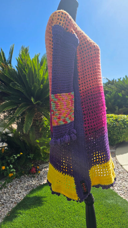 Spectrum Sunset crochet dress side detail — rainbow cuff band and UPLIFE label