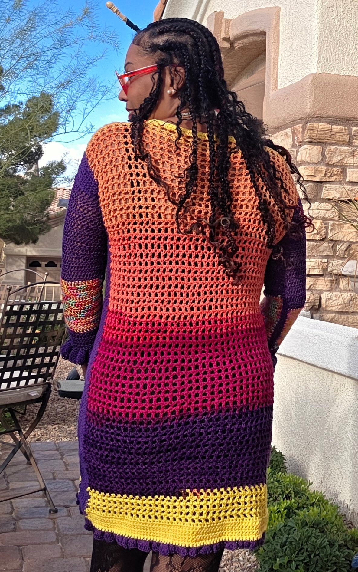 Spectrum Sunset crochet dress worn — back view, sunset gradient from coral to royal purple with sunny yellow hem