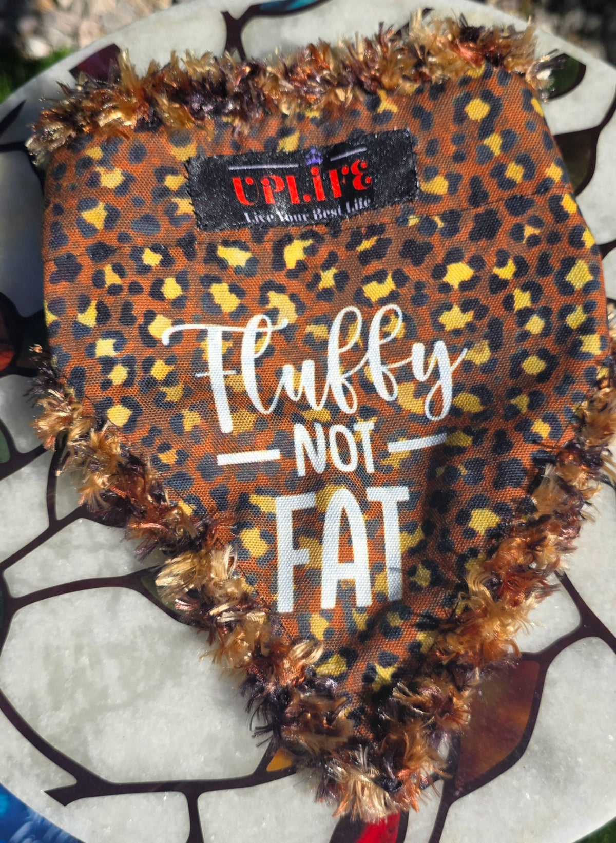Fluffy NOT FAT Dog Bandana, flat front view showing leopard print, Fluffy NOT FAT lettering and sewn-in UPLIFE label