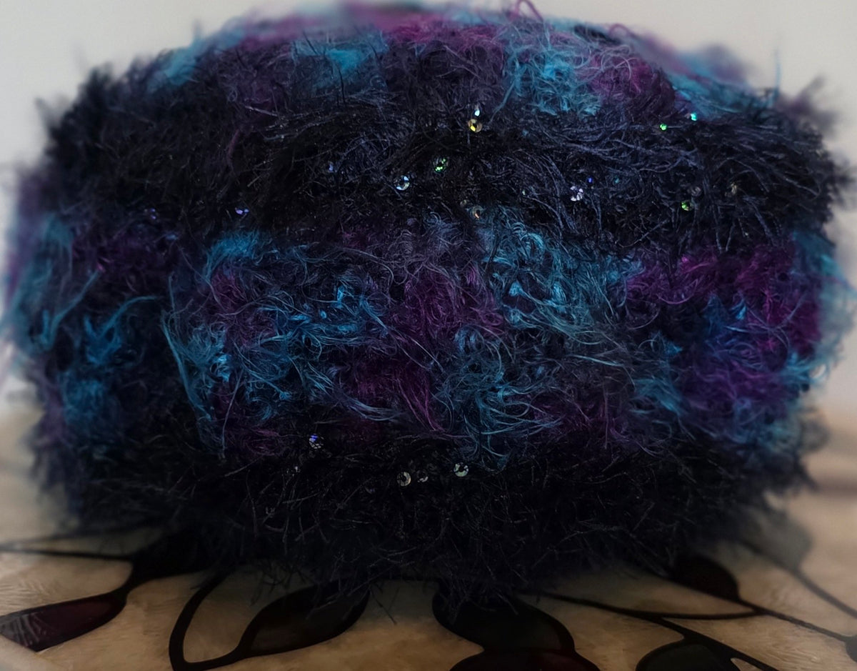 Blue Star hat showing sequined yarn texture in purple, sky blue and navy