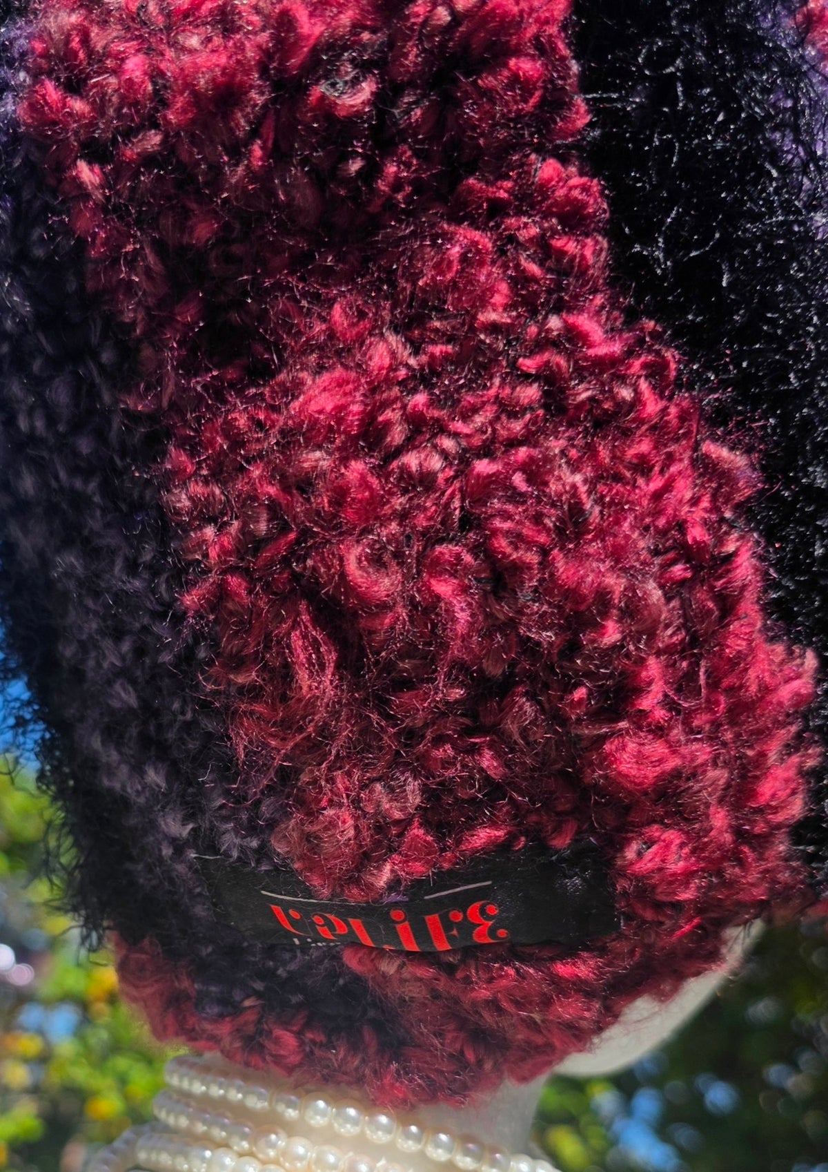 Close-up of the sewn-in UPLIFE label on the Amethyst Queen Hat